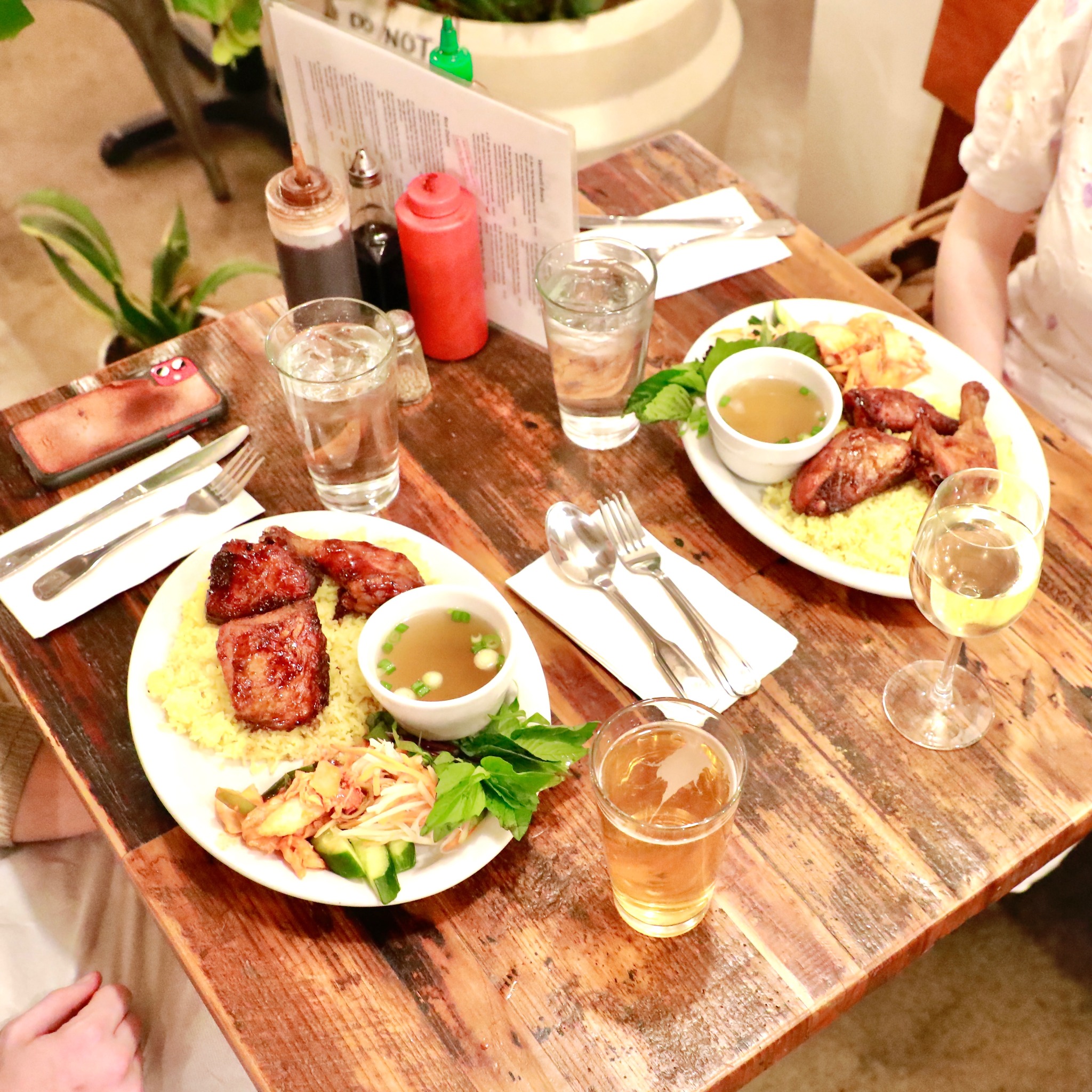 Vietnamese rice plates with grilled meat and fresh herbs at La Cà 38th