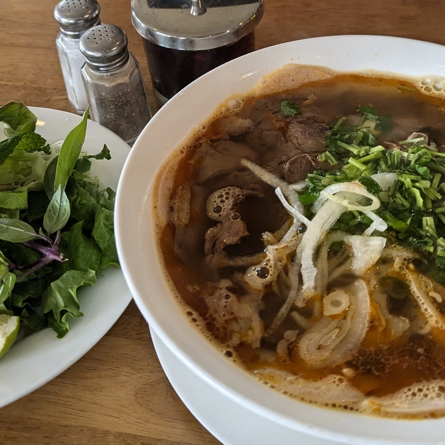 Phở and fresh herb plate at La Cà 38th in Lincoln District, Tacoma