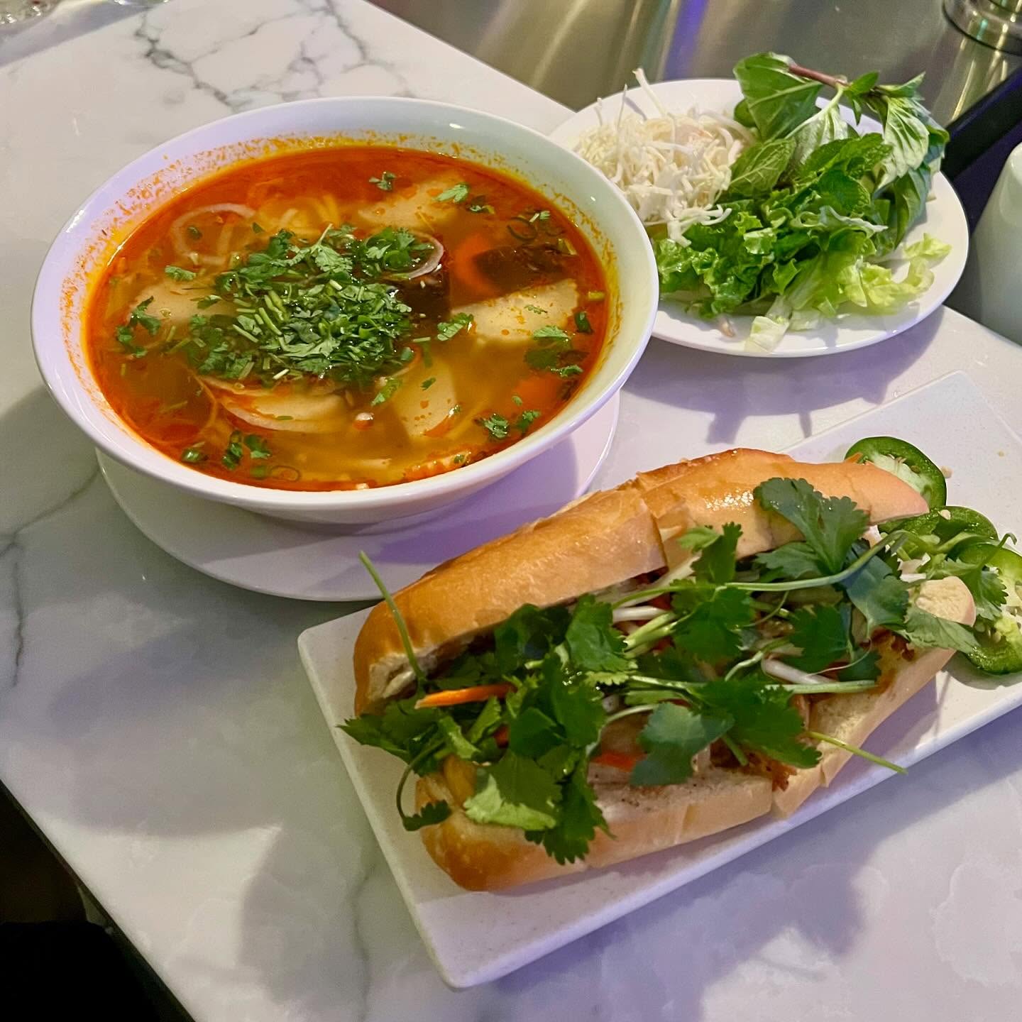 Vietnamese noodle soup with fresh herbs and bánh mì at La Cà 38th